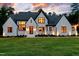 Charming two-story home featuring a modern exterior, black window trim, and a well-manicured lawn at 92 Bluffside Ct, Pittsboro, NC 27312