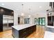 Open kitchen area with a large island, stainless appliances, and lots of counter space at 92 Bluffside Ct, Pittsboro, NC 27312