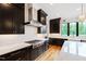 Beautiful kitchen featuring quartz countertops, dark cabinets, and stainless appliances at 92 Bluffside Ct, Pittsboro, NC 27312