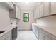 Functional laundry room featuring abundant storage and stylish patterned flooring at 92 Bluffside Ct, Pittsboro, NC 27312