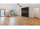 Open living room features hardwood floors, a modern fireplace, and staircase access at 92 Bluffside Ct, Pittsboro, NC 27312