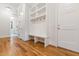 Bright mudroom featuring built-in storage, bench, and coat hooks at 92 Bluffside Ct, Pittsboro, NC 27312