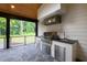 Outdoor kitchen with built-in grill, stainless steel drawers and cabinets, and dark countertops at 92 Bluffside Ct, Pittsboro, NC 27312