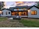 The rear of the home features an outdoor patio, cooking area, and a well-maintained yard at 92 Bluffside Ct, Pittsboro, NC 27312