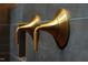 Close-up of elegant, modern gold shower fixtures set against dark tile in luxury bath at 92 Bluffside Ct, Pittsboro, NC 27312