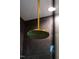 A sleek rainfall shower head in gold is set against dark tile in this luxury bathroom at 92 Bluffside Ct, Pittsboro, NC 27312
