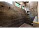 A modern shower boasts dark tile with gold fixtures, a rainfall shower head, and a built-in niche at 92 Bluffside Ct, Pittsboro, NC 27312