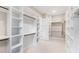 A spacious, white walk-in closet offers ample storage with shelving and hanging space at 92 Bluffside Ct, Pittsboro, NC 27312