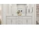 Modern bathroom boasts double sinks, sleek white cabinets, and elegant fixtures for a clean and contemporary design at 304 Calvander Ln, Apex, NC 27539