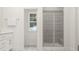 Well-lit bathroom showcasing a glass-enclosed shower with neutral-toned tiles and a convenient towel rack at 304 Calvander Ln, Apex, NC 27539