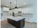 Modern kitchen featuring a large island, white cabinets, and stainless steel appliances at 0001 Luke Lane, Cedar Grove, NC 27231
