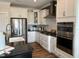 Bright kitchen featuring white cabinets, stainless steel appliances, and granite countertops at 0001 Luke Lane, Cedar Grove, NC 27231