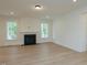 Bright living room with hardwood floors, fireplace, and large windows for natural light at 0001 Luke Lane, Cedar Grove, NC 27231