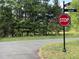 Image of a street intersection featuring a stop sign and street signs surrounded by lush greenery at 0001 Luke Lane, Cedar Grove, NC 27231