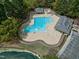 Aerial view of community pool, kiddie pool, pool house, and lush landscaping at 101 Goldenthal Ct, Cary, NC 27519