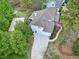 Aerial view of home with three-car garage, screened porch, basketball court, and luscious landscaping at 101 Goldenthal Ct, Cary, NC 27519