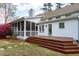 Beautiful backyard featuring a screened porch, wooden deck, and well-maintained landscaping at 101 Goldenthal Ct, Cary, NC 27519