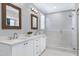 Bright bathroom featuring a double vanity, sleek countertops, and a glass-enclosed walk-in shower at 101 Goldenthal Ct, Cary, NC 27519