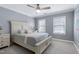This bedroom has a decorative bed, carpet, and natural light from the windows at 101 Goldenthal Ct, Cary, NC 27519