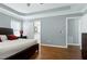 Spacious bedroom boasts a large bed, hardwood floors, a ceiling fan, and bright natural light at 101 Goldenthal Ct, Cary, NC 27519
