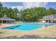 Community pool with lounge chairs, poolside pavilions, and mature landscaping at 101 Goldenthal Ct, Cary, NC 27519