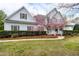 Charming two-story home with a manicured lawn, blooming tree, and inviting front porch at 101 Goldenthal Ct, Cary, NC 27519