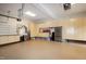 Spacious garage with epoxy floors and ample storage cabinets including a stainless steel refrigerator at 101 Goldenthal Ct, Cary, NC 27519