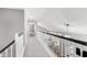 Hallway with a view of the foyer featuring an elegant chandelier and spindled railing at 101 Goldenthal Ct, Cary, NC 27519