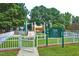 Fenced-in community playground with slides and climbing structures, perfect for Gathering fun at 101 Goldenthal Ct, Cary, NC 27519
