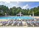 Community pool with lounge chairs, umbrellas, and a clear blue swimming pool at 101 Goldenthal Ct, Cary, NC 27519