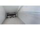 Storage closet under the eaves with carpet and built-in shelves at 101 Goldenthal Ct, Cary, NC 27519