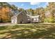 Large brick home exterior with a spacious yard, deck, and attached garage at 1021 Reaves Dr Dr, Chapel Hill, NC 27516