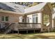 Back exterior of home featuring a wooden deck and brick construction at 1021 Reaves Dr Dr, Chapel Hill, NC 27516