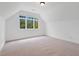 Bright bedroom with slanted ceilings and large window, filled with natural light at 1021 Reaves Dr Dr, Chapel Hill, NC 27516