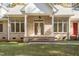 Charming brick home featuring a covered front entrance with classic columns and ample natural light at 1021 Reaves Dr Dr, Chapel Hill, NC 27516