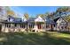 Charming brick home with well-maintained lawn, a covered porch, and double red front doors at 1021 Reaves Dr Dr, Chapel Hill, NC 27516