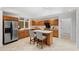 Traditional kitchen with oak cabinetry, stainless steel appliances, and a cozy breakfast bar at 1021 Reaves Dr Dr, Chapel Hill, NC 27516
