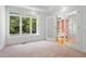 Sun-drenched living room with large windows, double French doors, and neutral carpet at 1021 Reaves Dr Dr, Chapel Hill, NC 27516