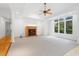 Cozy living room with a fireplace, neutral carpet, and a large window for natural light at 1021 Reaves Dr Dr, Chapel Hill, NC 27516