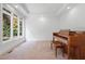 Spacious living room with tray ceiling, large windows, and a beautiful piano at 1021 Reaves Dr Dr, Chapel Hill, NC 27516
