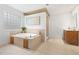 Luxurious bathroom with garden tub, tile surround, vanity, and glass block window at 1021 Reaves Dr Dr, Chapel Hill, NC 27516