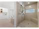 Walk-in shower with tiled walls and floors, dual shower heads, and glass block window at 1021 Reaves Dr Dr, Chapel Hill, NC 27516