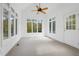 Bright sunroom with large windows, vaulted ceiling, ceiling fan, and neutral carpeting at 1021 Reaves Dr Dr, Chapel Hill, NC 27516