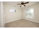 Bedroom with neutral carpet, ceiling fan, and arched transom window above the standard window at 1023 Kelton Cottage Way, Morrisville, NC 27560