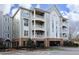 Inviting condo complex features multiple levels with private balconies and covered parking at 1023 Kelton Cottage Way, Morrisville, NC 27560