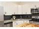 Bright kitchen featuring granite countertops, stainless steel appliances, and black backsplash at 1023 Kelton Cottage Way, Morrisville, NC 27560