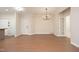 Open-concept living room with hardwood floors, elegant lighting, and ample space for entertaining at 1023 Kelton Cottage Way, Morrisville, NC 27560