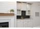 Living room features a marble fireplace, wet bar, and custom cabinets at 1023 Kelton Cottage Way, Morrisville, NC 27560
