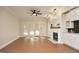Open concept living room with fireplace and access to the backyard via sliding glass doors at 1023 Kelton Cottage Way, Morrisville, NC 27560