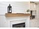 Living room featuring a fireplace with a wood mantel and white cabinetry at 1023 Kelton Cottage Way, Morrisville, NC 27560